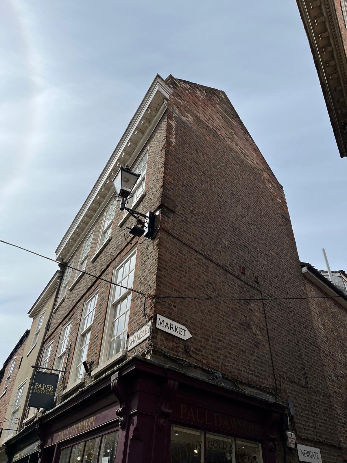 A building at the entrance to the Shambles displays the street sign