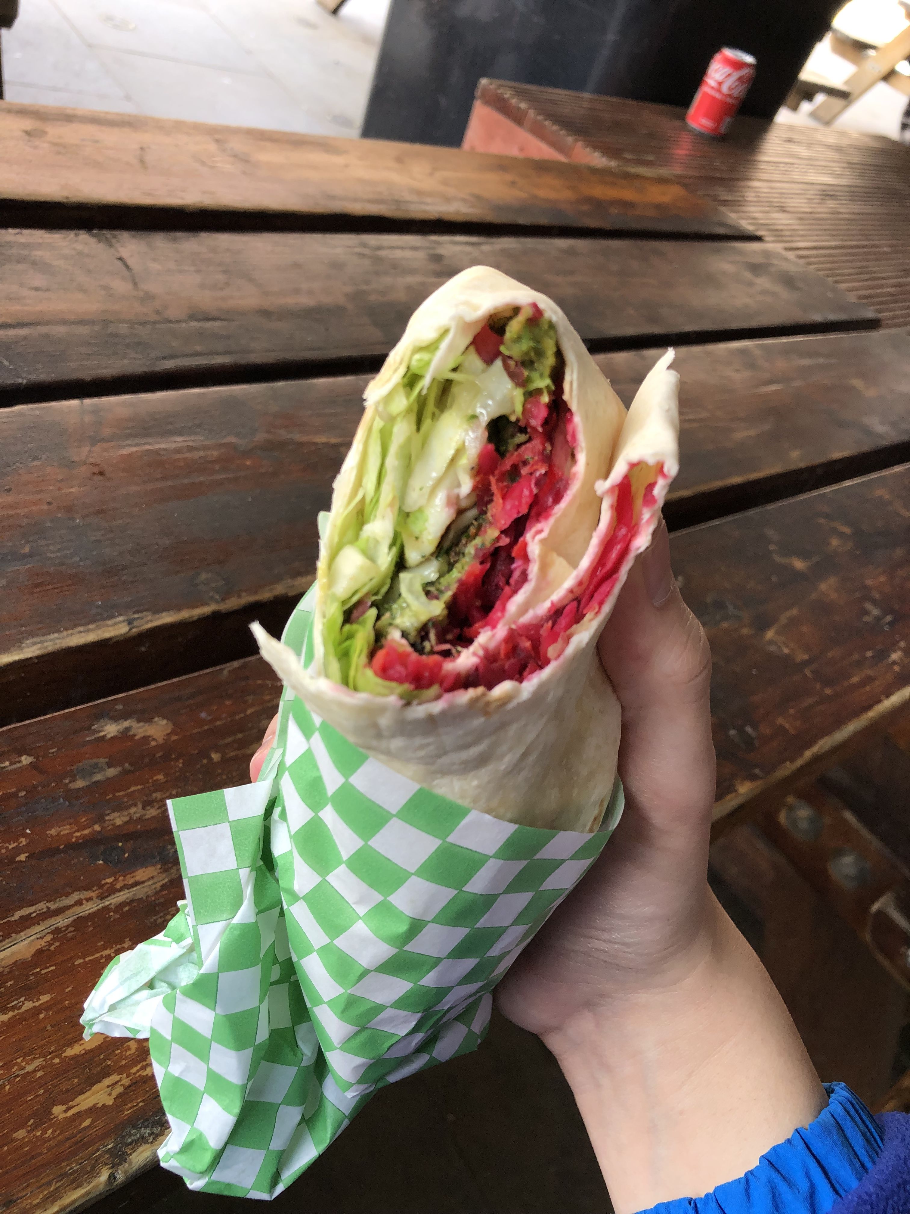 Eating the wrap reveals bright pinks and greens filling the wrap